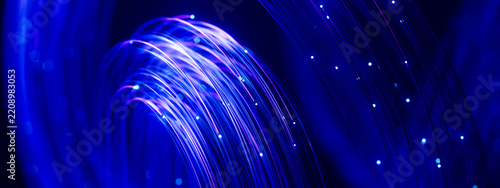 Glowing fiber arch with cascading digital particles on blue background 3D