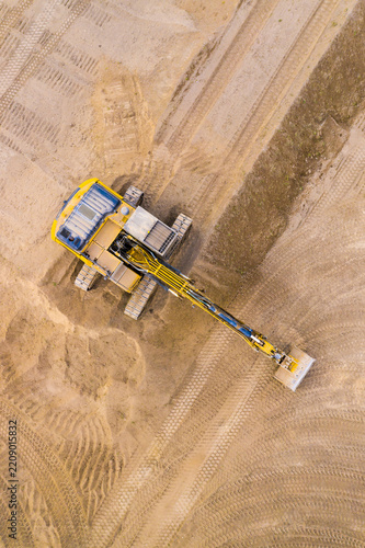 Excavator on a construction site. Aerial view from european industry.
