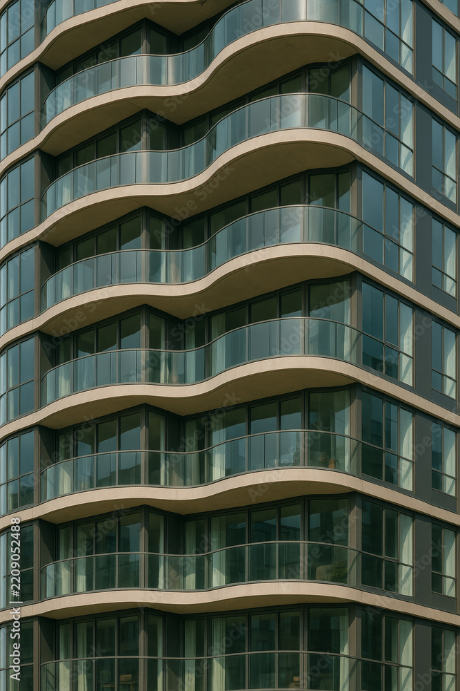 Fototapeta premium High rise building facade with repeating curved balconies