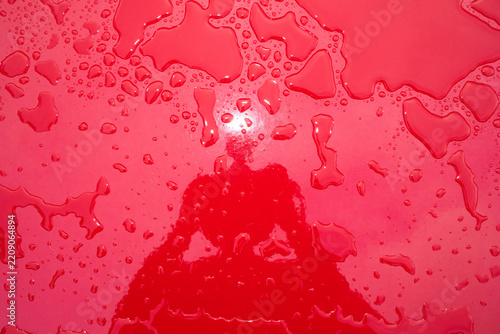 Water Droplets on Bright Red Surface With Reflection