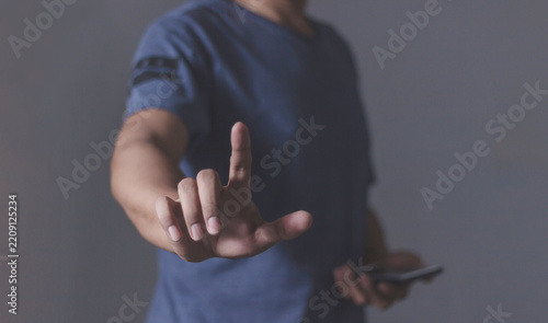Young man using smartphone to select and interact with digital content for business.