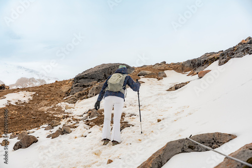 Trekker ascends glacier on Cayambe volcano in Ecuador