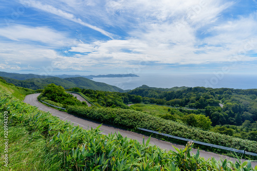 Panoramic view of winding coastal road and Sea of Japan from Chokandai Observatory, Tsugaru Peninsula, Aomori, Japan
