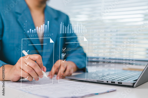 Businessman reviewing performance reports and compliance checklist on digital dashboard, data analytics, financial auditing, project management, reporting accuracy, and corporate governance.