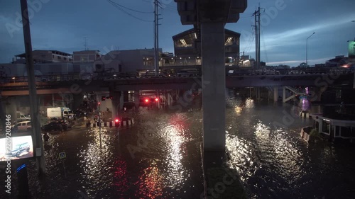 Street intersection covered with floodwater after heavy rain at night.