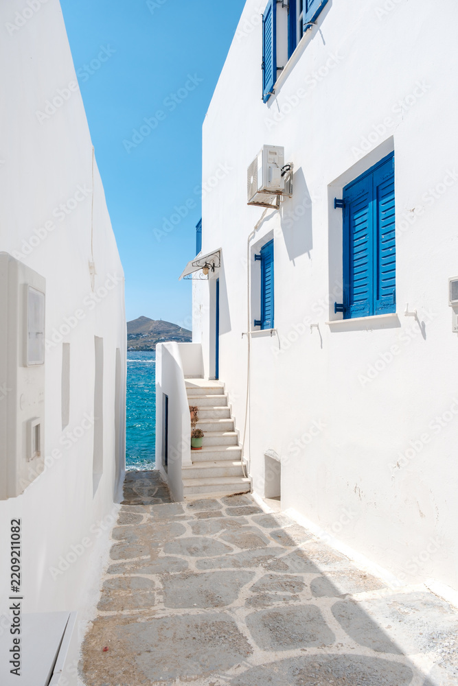 Fototapeta premium Charming alleyway in Naousa with blooming bougainvillea in Paros Greece