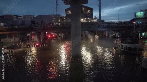 Street intersection covered with floodwater after heavy rain at night.