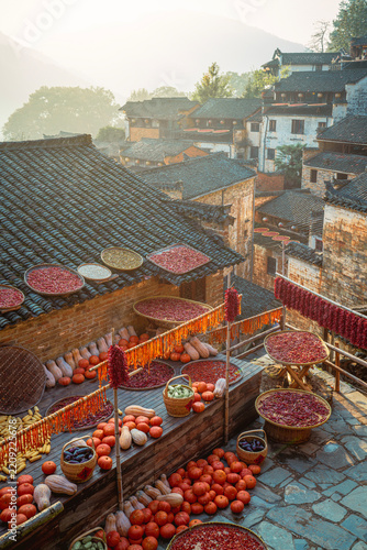 Obraz na plátně Colorful autumn harvest drying on rooftops in Huangling, China