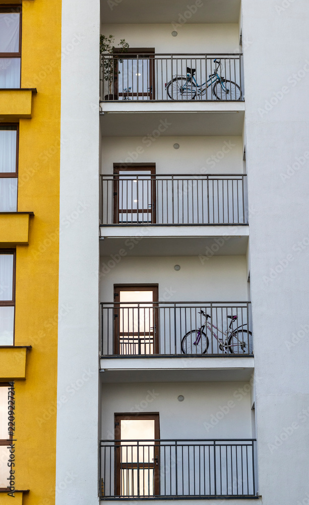 Obraz premium Modern apartment building balconies with parked bicycles. Concept