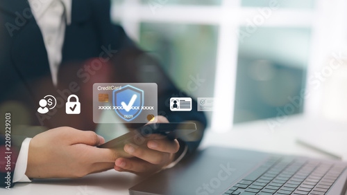 Businessman using smartphone for secure online credit card payment, digital banking protection, identity verification, and safe financial transaction at office.