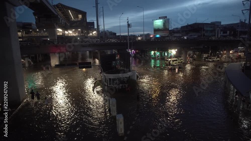 Street intersection covered with floodwater after heavy rain at night.