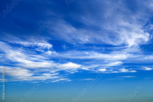 Blue sky with soft white clouds on clear day