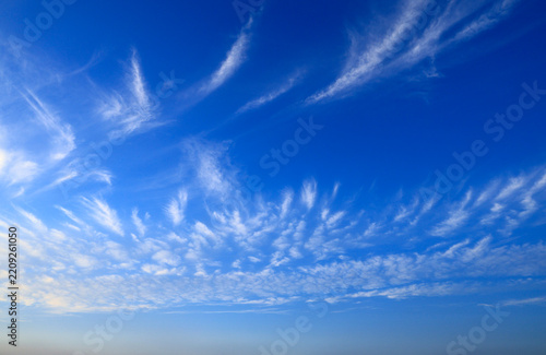Blue sky with soft white clouds on clear day