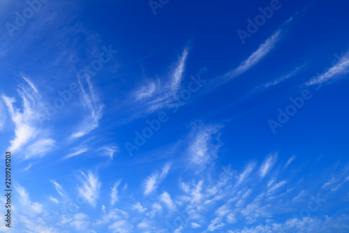 Blue sky with soft white clouds on clear day