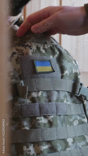 Soldier packing tactical equipment and gear into military backpack