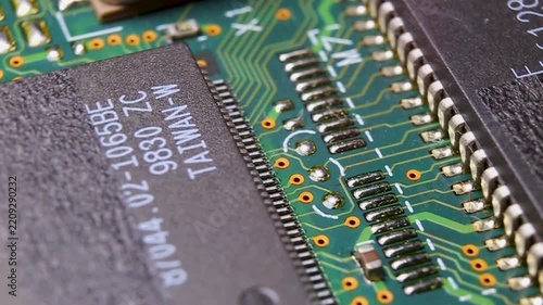 View of a part of an electronic printed circuit board with components and a microcircuit, video macro shooting