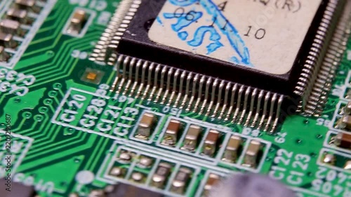 Part of an electronic printed circuit board with electronic components and connections, video macro shooting