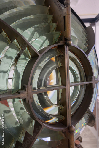 Fotografie Close up of a large vintage fresnel lens for lighthouse in brass frame