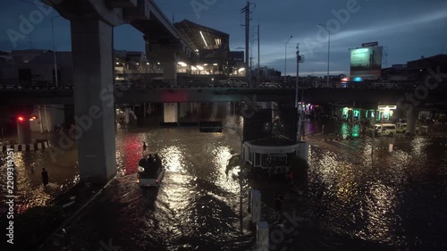 Street intersection covered with floodwater after heavy rain at night.