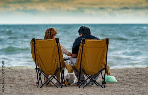 People sitting on beach chairs relaxing in Thailand