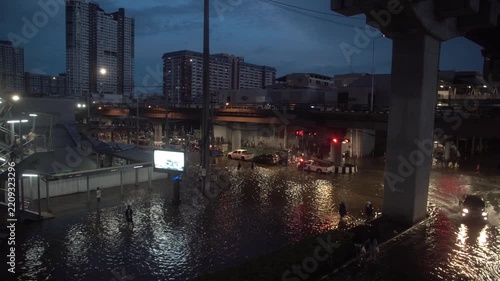 Street intersection covered with floodwater after heavy rain at night.