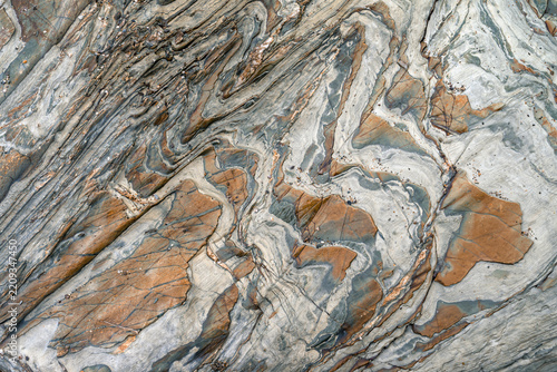 Abstract mineral pattern formed by various mineral encrustations on a slate base