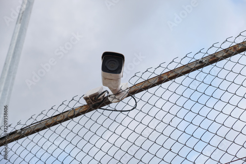 Security camera mounted on a wire fence for safety and system monitoring