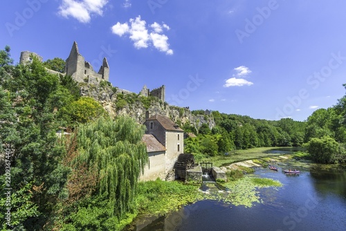 View of castle ruins and river Anglin with an old mill, Angles-sur-l'Anglin, Département Vienne, France