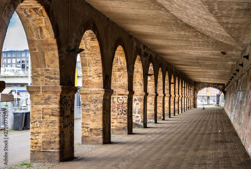 Historic stone archway corridor with graffiti details for urban architectural branding, Bremen, Germany