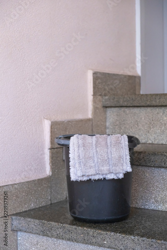 Minimalist Cleaning Setup with Gray Mop and Bucket.