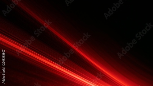 Abstract red light streaks forming diagonal beams on dark black background