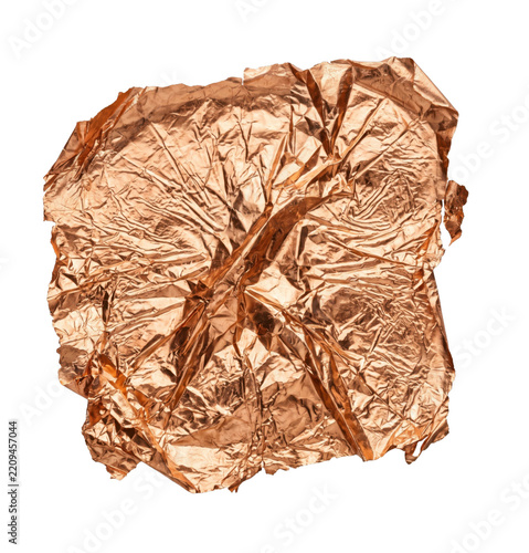 Crumpled sheet of metallic copper foil with a reflective texture isolated on white background