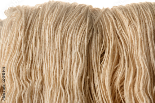Raw cotton yarn natural fiber closeup texture beige color textile material soft organic thread industry macro background detail