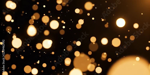 Abstract background with shimmering golden bokeh lights against a dark backdrop, creating a festive and magical atmosphere.