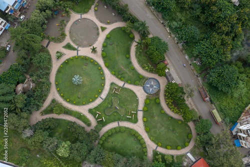 Aerial view of a public park in Karad featuring circular green lawns, paved walkways, and lush trees in Karad, Maharashtra, India.