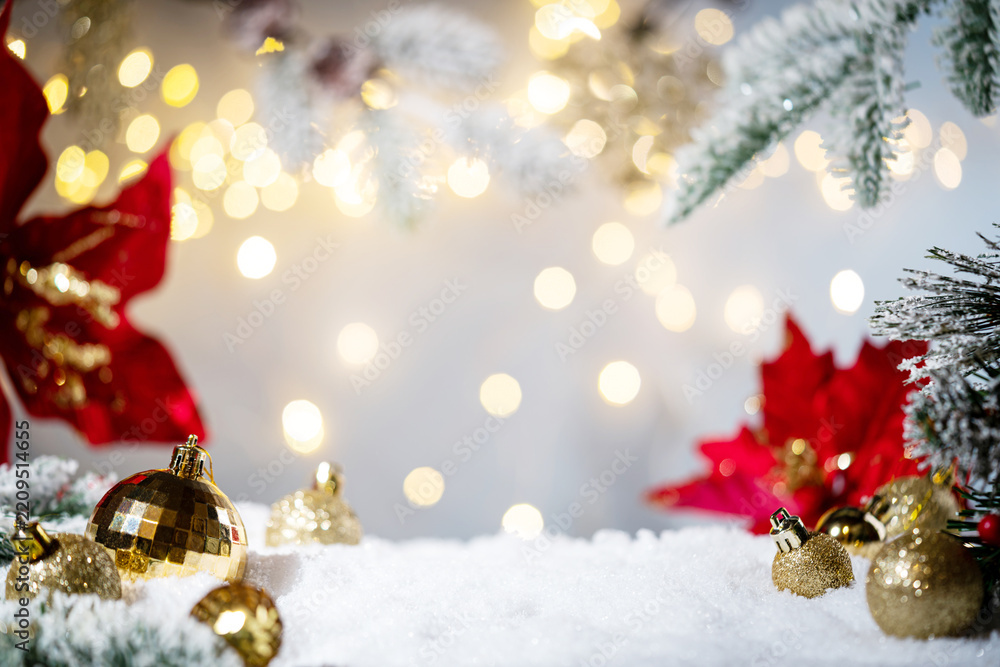 Fototapeta premium Christmas Holiday background with snow, fir tree and decorations with christmas light behind