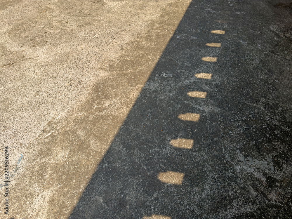 Obraz premium Wall Shadow Cast on Aged Concrete Floor Surface