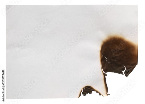 Burnt hole in paper sheet isolated on white background