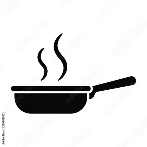 Hot frying pan with steam rising from it cooking food