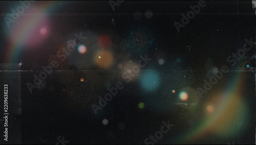 Abstract vintage dark film texture with soft colorful bokeh, pink and teal lens flare glow, orange and blue light circles, horizontal scratches, dust and heavy grain on a black background for overlays