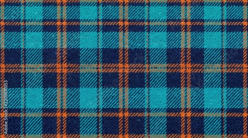 Bright orange and turquoise plaid flannel fabric texture featuring dark navy wool yarn threads