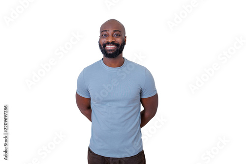 Black man with a beard and bald head smiling, standing with hands behind back, portraying happiness and confidence. Transparent background