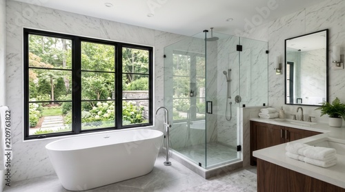 Modern bathroom featuring a freestanding tub and glass shower with garden view