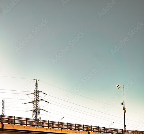 Industrial power transmission tower against clear blue sky