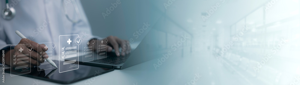 Obraz premium Digital healthcare workflow showing medical professional reviewing electronic checklists and patient records on laptop and tablet in modern hospital setting with secure technology