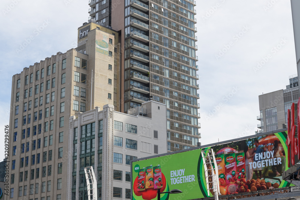 Obraz premium digital billboard featuring advertising for Del Monte beverages and view of historic buildings Hermant Building / HNR Properties Limited (Imperial Optical) located at 19 and 21 Dundas Square, Toronto