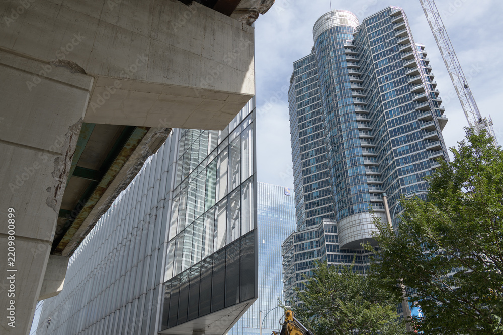 Fototapeta premium undercroft of elevated Gardiner Expressway, dramatic geometric tip of 10 York Street (south facing side) and Waterclub Condominiums, viewed from Harbour St, Toronto