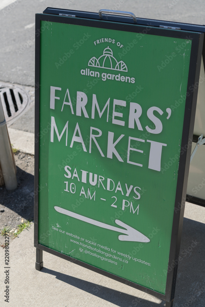 Obraz premium sidewalk a-frame poster featuring Allan Gardens Farmers' Market info in Toronto
