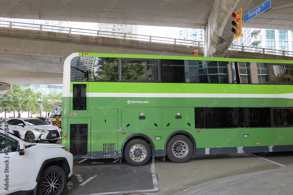 Fototapeta premium rear of a Metrolinx Go bus heading westbound on Lake Shore Blvd W at Yonge St, Toronto