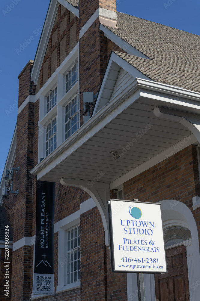 Fototapeta premium sign outside Uptown Studio located at 527A Mount Pleasant Rd, and facade of Mount Pleasant Baptist Church, Toronto